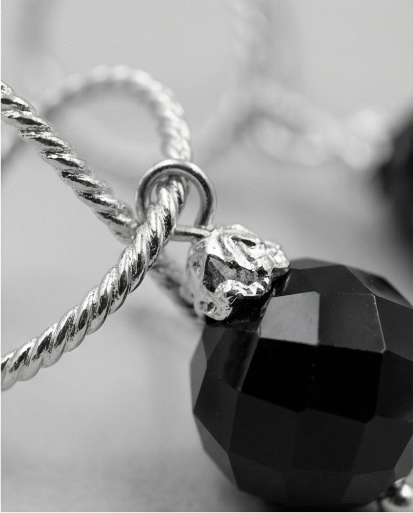White gold omega earrings with onyx stone