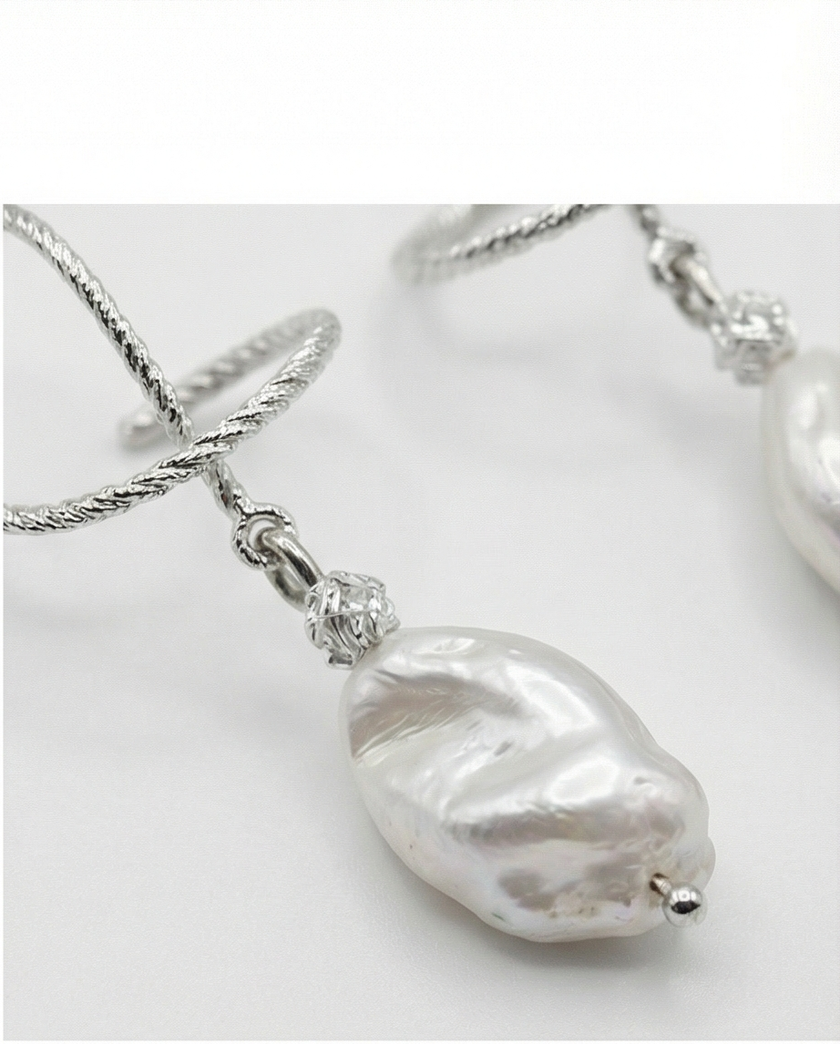 Silver omega earrings with an artificial brook pearl