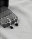White gold omega earrings with onyx stone