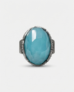 An oval silver ring with an ocean-hued opalite