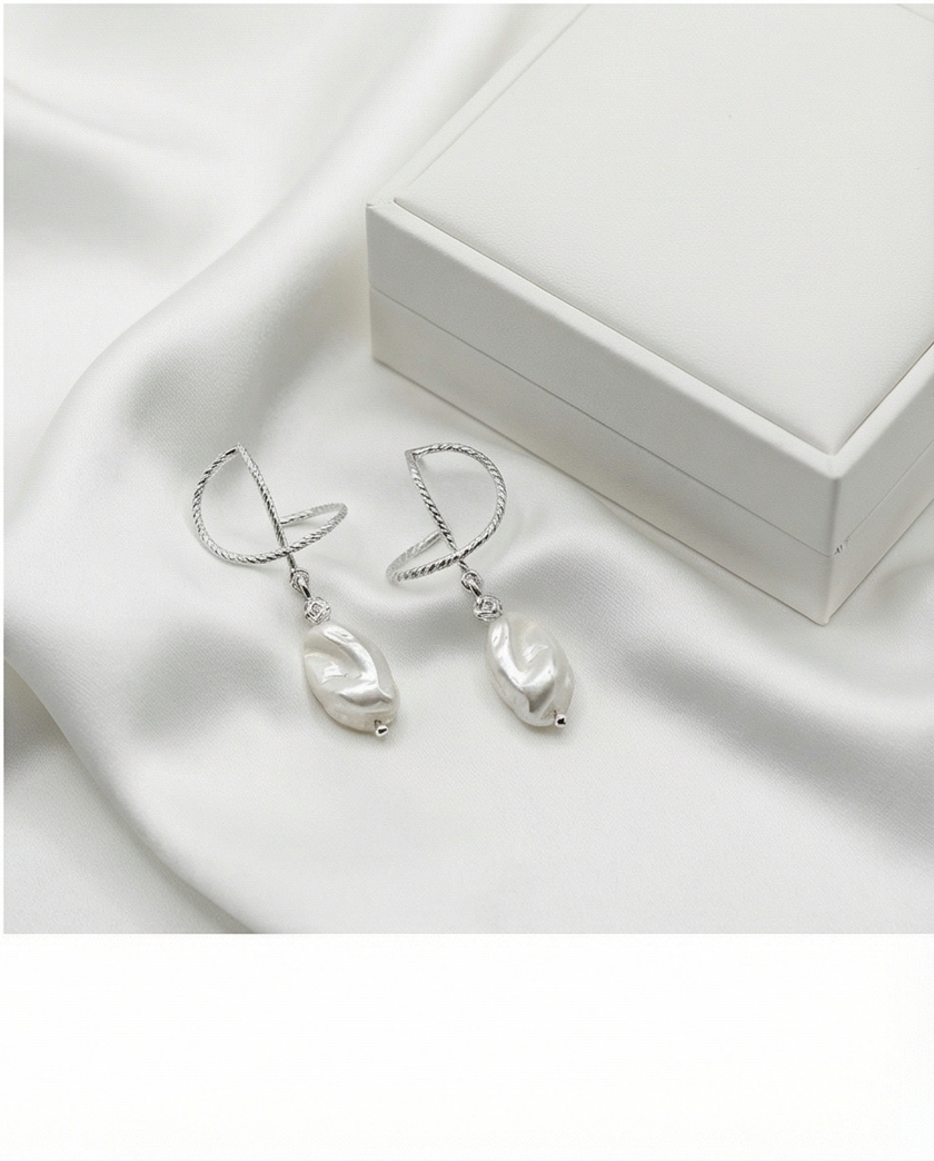 Silver omega earrings with an artificial brook pearl