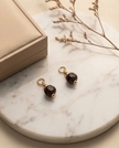 Regina 14 karat gold earrings with garnet charms