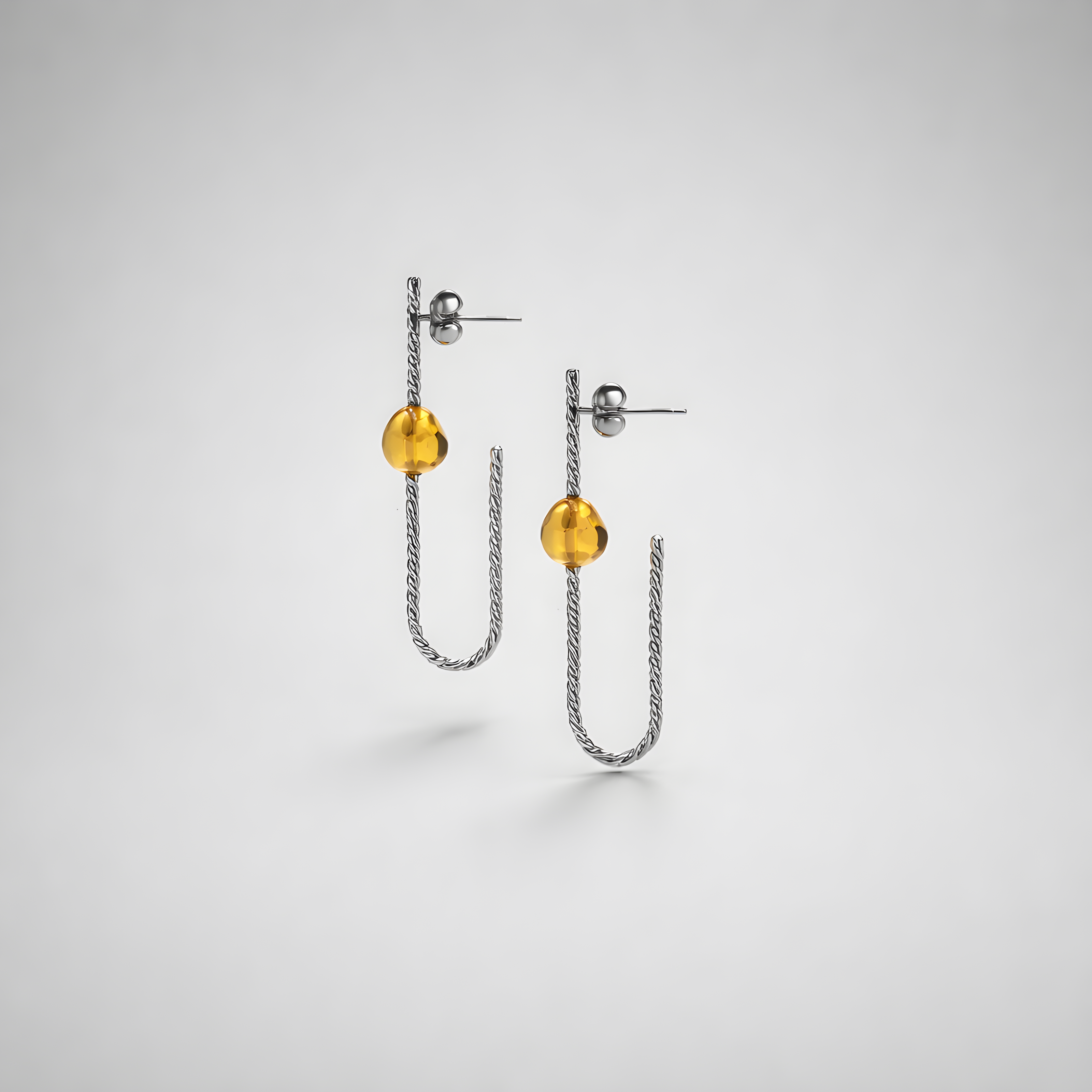 Earrings designed with amber
