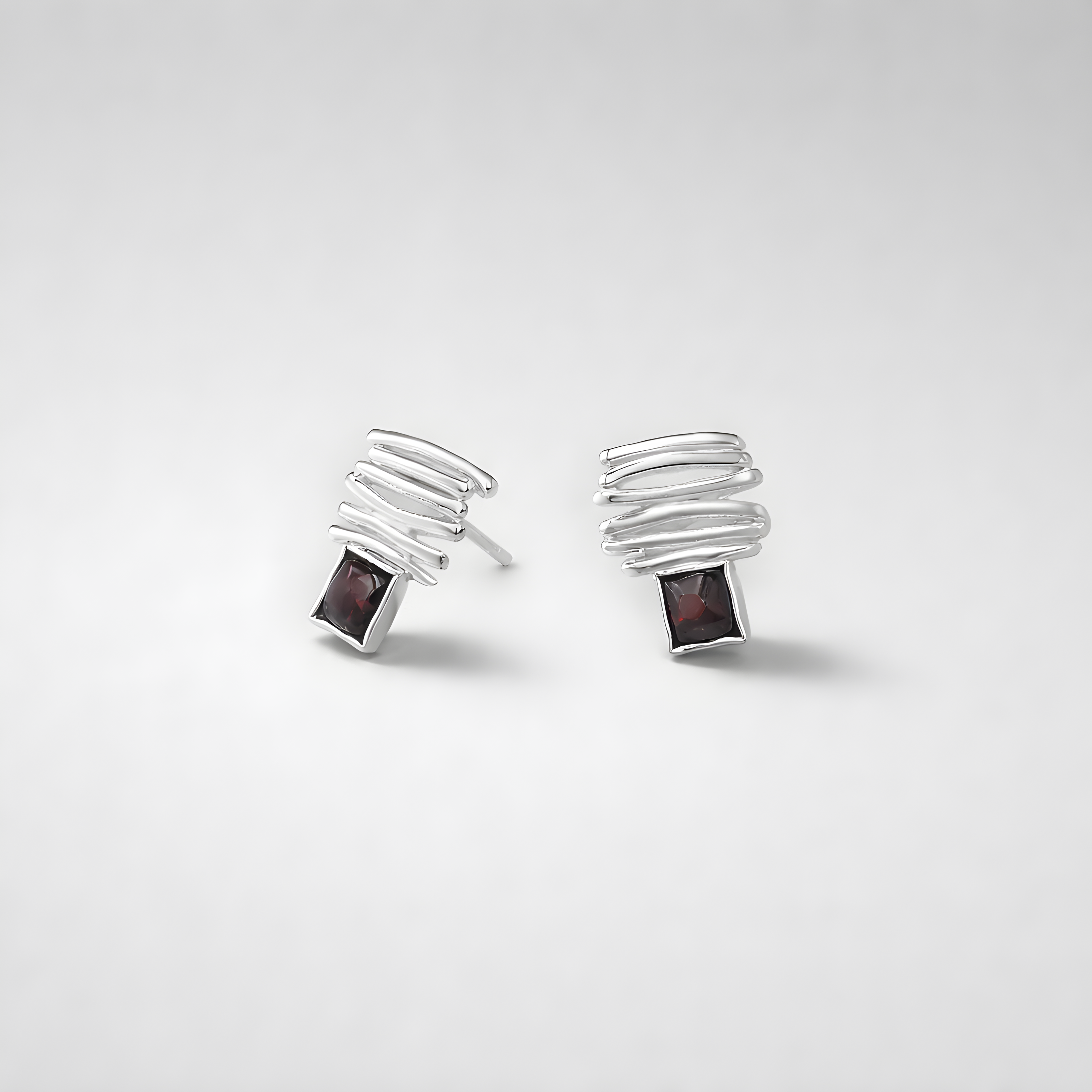 14 carat white gold earrings with garnet stones