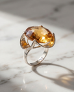 Silver ring with a crystal in the shade of citrine