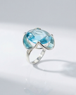 A silver ring combined with a crystal in a shade of aquamarine