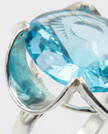 A silver ring combined with a crystal in a shade of aquamarine