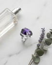 Silver ring with an amethyst colored crystal