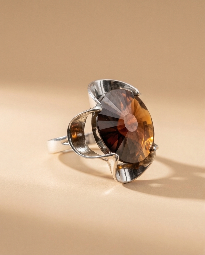 A silver ring combined with a crystal in the shade of garnet