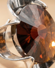 A silver ring combined with a crystal in the shade of garnet