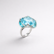 A silver ring combined with a crystal in a shade of aquamarine