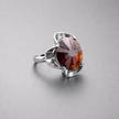 A silver ring combined with a crystal in the shade of garnet