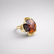 A silver ring combined with a crystal in the shade of garnet