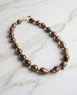 Pearl necklace in a drop of chocolate-toned rock
