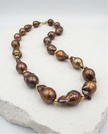 Pearl necklace in a drop of chocolate-toned rock