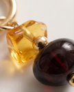 Atziaram with a dark and light amber charm