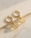 A set of 14 carat gold earrings with yellow opal and citrine charms
