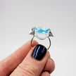 A silver ring combined with a crystal in a shade of aquamarine